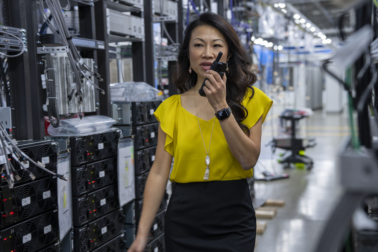 woman holding two-way motorola radio