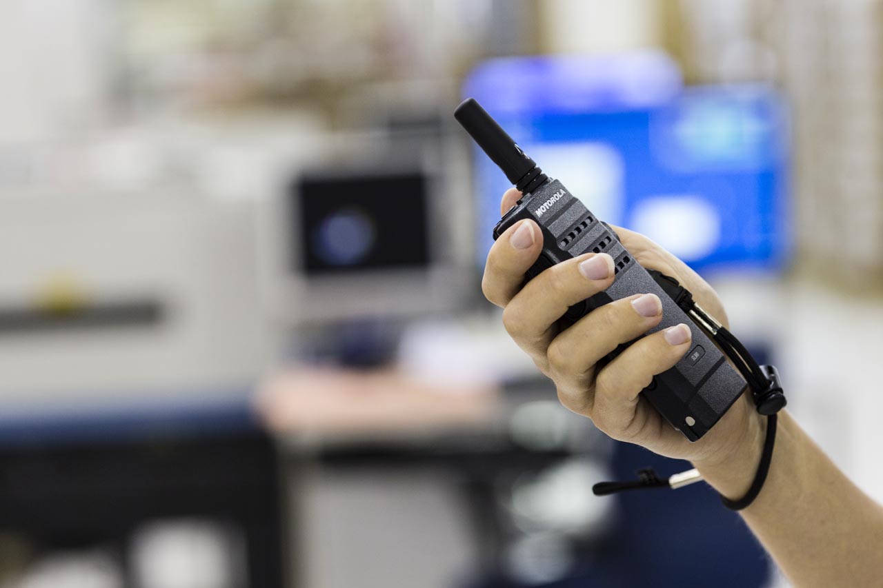 person using the smart features of a Motorola two-way radio 