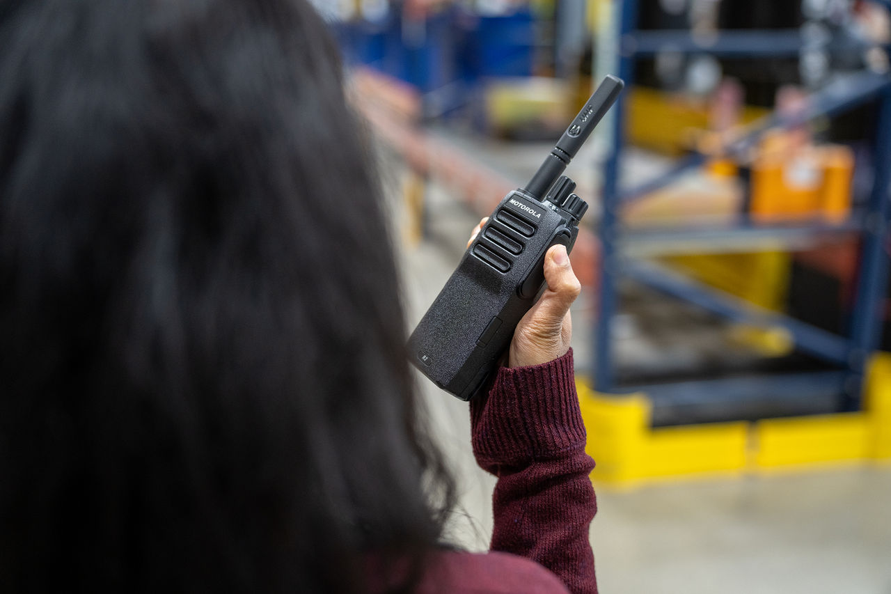 person using Motorola two-way radio for RCV